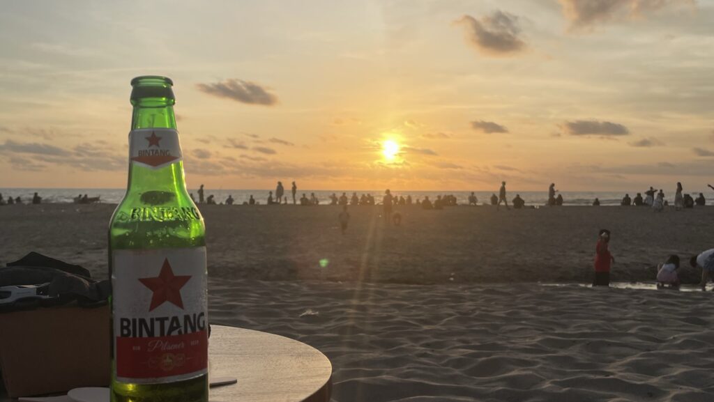 Bintang Beer on a table on Seminyak Beach during sunset