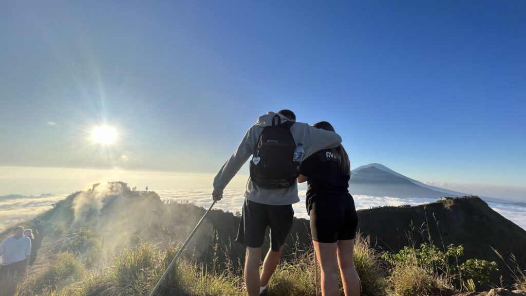 Two people standing on Mount Batur Summit in Ubud
