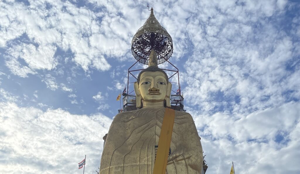 Standing Buddha statue at Wat Intharawihan